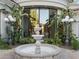 Close up of circular driveway and outdoor fountain. Lush green landscaping and a modern home design at 8815 N 65Th St, Paradise Valley, AZ 85253