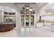 Spacious great room features travertine flooring, chandelier lighting and french door access to outdoor pool at 8815 N 65Th St, Paradise Valley, AZ 85253
