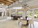 Spacious great room with high ceilings, wooden beams, dining area, kitchen, and access to the outdoors at 8815 N 65Th St, Paradise Valley, AZ 85253