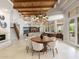 Spacious great room with high ceilings, wooden beams, dining area, living room, and staircase at 8815 N 65Th St, Paradise Valley, AZ 85253