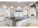 Open kitchen features granite countertops, stainless steel appliances, and large island with breakfast bar at 8815 N 65Th St, Paradise Valley, AZ 85253