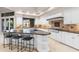 Spacious kitchen features granite countertops, white cabinetry, bar seating and stainless steel appliances at 8815 N 65Th St, Paradise Valley, AZ 85253