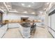 Open kitchen with large island, marble countertops, white cabinets, and tile backsplash at 8815 N 65Th St, Paradise Valley, AZ 85253
