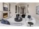 Spacious living room with fireplace, modern furniture, and grand entrance with ornate doors and pillars at 8815 N 65Th St, Paradise Valley, AZ 85253