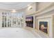 Bright living room with fireplace and large windows offering ample natural light and outdoor views at 8815 N 65Th St, Paradise Valley, AZ 85253