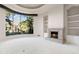 Inviting living room featuring a stone fireplace, built-in shelves, and large windows with a view at 8815 N 65Th St, Paradise Valley, AZ 85253