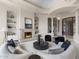 Bright living room featuring a stone fireplace, curved sofa, accent chairs, and grand entry at 8815 N 65Th St, Paradise Valley, AZ 85253