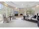 Spacious living room featuring a fireplace, large windows with shutters and a decorative ceiling at 8815 N 65Th St, Paradise Valley, AZ 85253