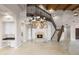 Spacious living area with a fireplace, chandelier, staircase, and beautiful flooring at 8815 N 65Th St, Paradise Valley, AZ 85253