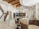 View of the living room and bar area featuring wood beam ceilings and stone floors at 8815 N 65Th St, Paradise Valley, AZ 85253