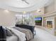 Comfortable living room with large windows, fireplace, TV, and a leather daybed at 8815 N 65Th St, Paradise Valley, AZ 85253