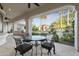 Covered patio with an outdoor dining set overlooking the pool and lush backyard at 8815 N 65Th St, Paradise Valley, AZ 85253