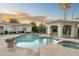 Inviting pool and spa area surrounded by lush landscaping and desert scenery at 8815 N 65Th St, Paradise Valley, AZ 85253