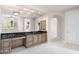 A vanity area with beautiful cabinetry, a large mirror, decorative sconces, and granite countertops at 8815 N 65Th St, Paradise Valley, AZ 85253