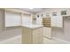 Spacious walk-in closet with central storage island, drawers, shelves and multiple hanging rods at 8815 N 65Th St, Paradise Valley, AZ 85253