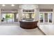 Entertainer's wet bar featuring a curved counter, custom cabinetry, and views of the pool and yard at 8815 N 65Th St, Paradise Valley, AZ 85253