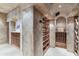 Custom wine cellar features arched ceilings, tiled floors and built-in wooden racks at 8815 N 65Th St, Paradise Valley, AZ 85253