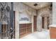 Unique wine cellar features a mosaic tile wall, tiled floors, and custom built-in storage at 8815 N 65Th St, Paradise Valley, AZ 85253