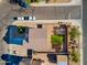 Aerial view of the home's roof, backyard with green grass, storage shed, and desert landscaping at 894 S Buena Vista Dr, Apache Junction, AZ 85120