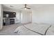Spacious bedroom with a large TV, ceiling fan, a glass door and neutral tones creates a calming atmosphere at 894 S Buena Vista Dr, Apache Junction, AZ 85120