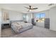 Spacious bedroom with a ceiling fan, large windows, and complementary bedside tables and dressers at 894 S Buena Vista Dr, Apache Junction, AZ 85120