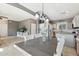 Bright dining space flows into the kitchen, featuring a modern light fixture and neutral decor at 894 S Buena Vista Dr, Apache Junction, AZ 85120