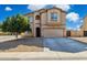 Inviting two-story home with a desert landscape, two-car garage, and a covered entry at 894 S Buena Vista Dr, Apache Junction, AZ 85120
