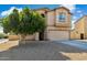 Charming two-story home featuring a two-car garage and a well-maintained gravel front yard at 894 S Buena Vista Dr, Apache Junction, AZ 85120