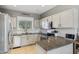 Modern kitchen with granite countertops, white cabinets, and stainless steel appliances at 894 S Buena Vista Dr, Apache Junction, AZ 85120