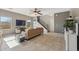 Spacious living room featuring a ceiling fan, tile flooring, and a staircase leading to the upper level at 894 S Buena Vista Dr, Apache Junction, AZ 85120