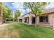 Spacious backyard features lush green grass and a covered patio at 9120 W Wescott Dr, Peoria, AZ 85382