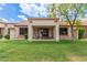 Lush green grass in backyard leading to the covered patio at 9120 W Wescott Dr, Peoria, AZ 85382