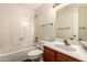 Bright bathroom features a shower-tub combo and wood vanity at 9120 W Wescott Dr, Peoria, AZ 85382