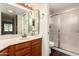 Bathroom featuring a large mirror, and a glass-enclosed shower at 9120 W Wescott Dr, Peoria, AZ 85382