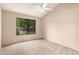 Neutral bedroom features large window overlooking the landscaped yard at 9120 W Wescott Dr, Peoria, AZ 85382