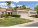 Attractive single-story house featuring a lush green lawn and palm trees at 9120 W Wescott Dr, Peoria, AZ 85382
