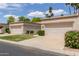 Inviting single-story home with a verdant lawn and a convenient two-car garage at 9120 W Wescott Dr, Peoria, AZ 85382