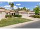 Charming single-story home with a well-manicured lawn, mature palm trees, and a two-car garage at 9120 W Wescott Dr, Peoria, AZ 85382