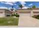 Alluring single-story house with a green lawn, attractive landscape, and spacious two-car garage at 9120 W Wescott Dr, Peoria, AZ 85382