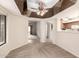 Open-concept living room features neutral carpet and a ceiling fan with mirror accents at 9120 W Wescott Dr, Peoria, AZ 85382