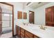 Bathroom featuring double sinks, large mirror, and access to a shower over tub combo at 9414 S La Rosa Dr, Tempe, AZ 85284