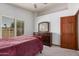 Bedroom with carpet, natural light, a wooden bed frame, and wooden dresser at 9414 S La Rosa Dr, Tempe, AZ 85284