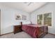 Bedroom with a wooden bed frame, carpet, natural light, and a view of artwork at 9414 S La Rosa Dr, Tempe, AZ 85284