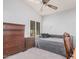 Bedroom with dark wood furniture, neutral carpet, and natural light from the window at 9414 S La Rosa Dr, Tempe, AZ 85284