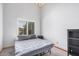 Cozy bedroom with a simple bed, neutral carpet, and natural light from the window at 9414 S La Rosa Dr, Tempe, AZ 85284