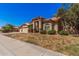 Landscaped front yard and well-maintained home featuring a three-car garage at 9414 S La Rosa Dr, Tempe, AZ 85284