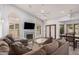 Bright living room boasts large windows, fireplace, and a sectional sofa for comfortable lounging at 9414 S La Rosa Dr, Tempe, AZ 85284