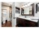 Well-lit bathroom with vanity, mirror, and walk-in shower with rock detail at 9450 E Becker Ln # 1071, Scottsdale, AZ 85260