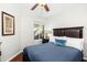 Comfortable bedroom with a dark wood bed frame, wood floors, and light walls at 9450 E Becker Ln # 1071, Scottsdale, AZ 85260