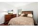 Bedroom with wood floors, bright walls, and natural lighting from the window and TV at 9450 E Becker Ln # 1071, Scottsdale, AZ 85260